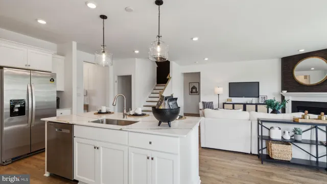 a kitchen with stainless steel appliances kitchen island granite countertop a sink a microwave a refrigerator and a stove