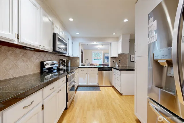 a kitchen with stainless steel appliances granite countertop a sink and cabinets