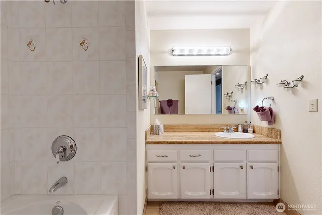 a bathroom with a bathtub and shower
