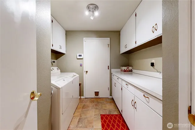 a view of a hallway with closet and a bathroom
