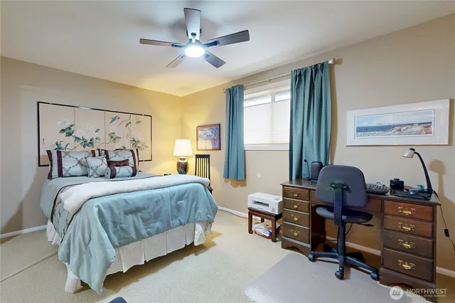 a bedroom with a bed and a desk