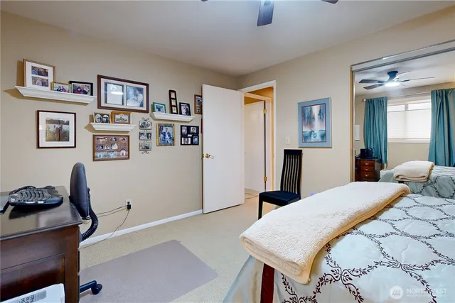 a spacious bedroom with a bed and a chandelier