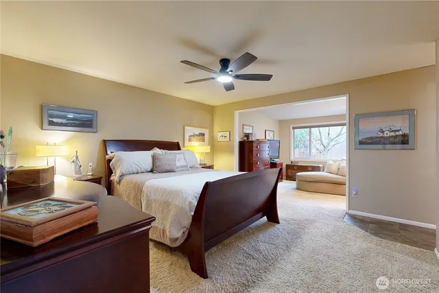a spacious bedroom with a large bed and a chandelier