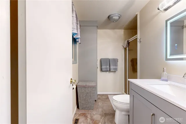 a bathroom with a toilet sink and mirror
