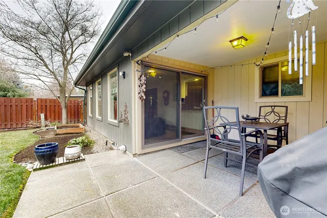 a backyard of a house with table and chairs