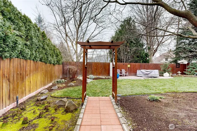 a backyard of a house with fire pit and outdoor seating