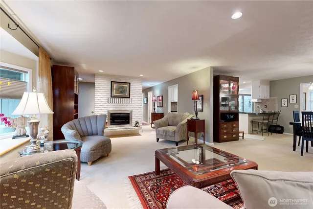 a living room with furniture fireplace and a window