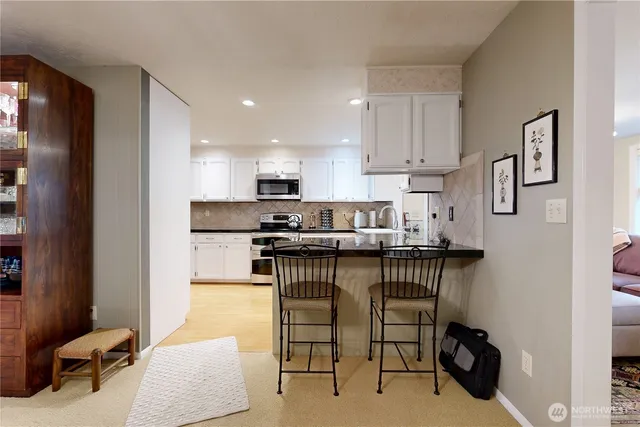 a kitchen with stainless steel appliances kitchen island granite countertop a sink and cabinets