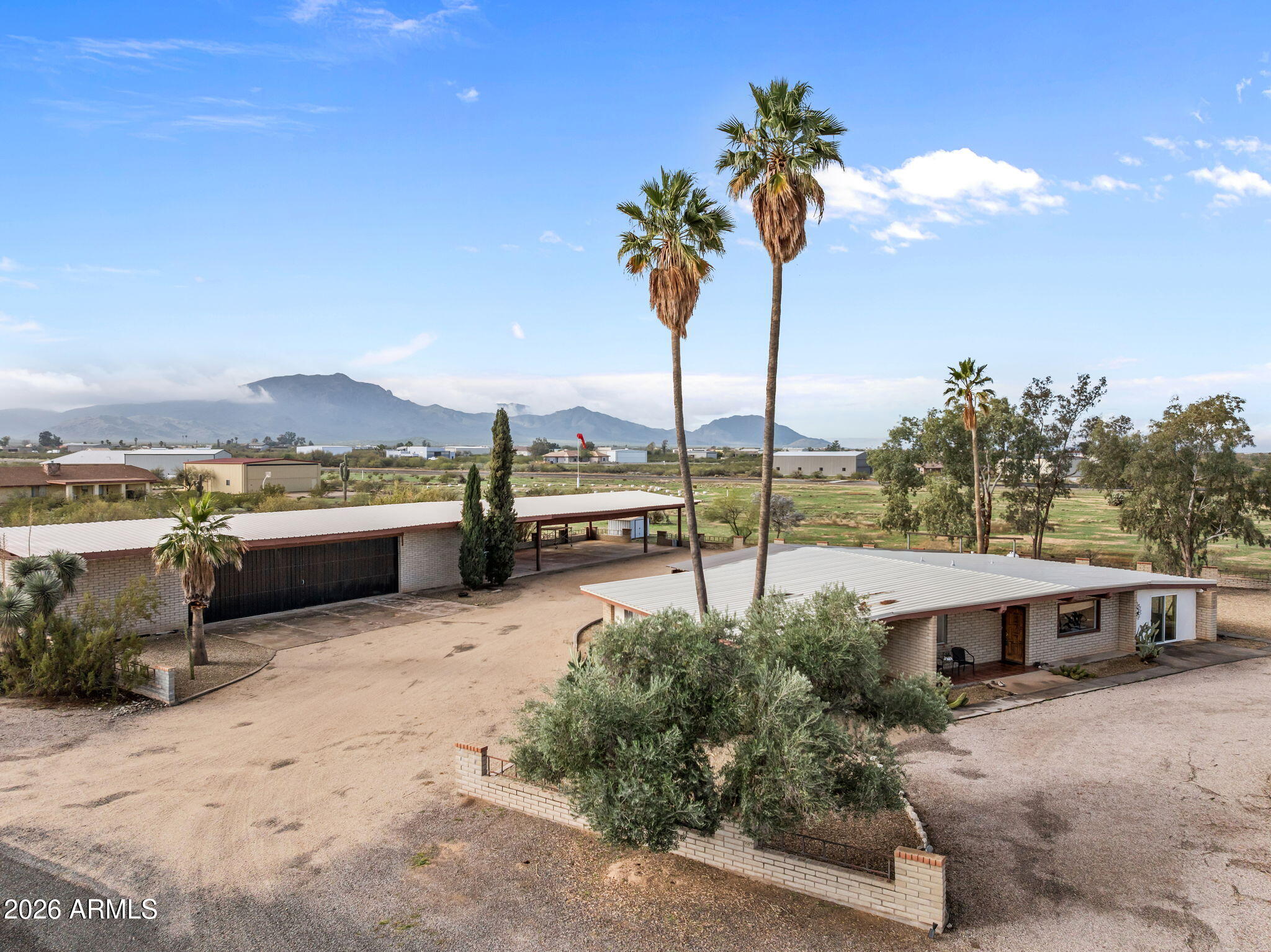 50907 West Iver Road Aguila, AZ 85320 - Photo 24 of 46 a view of a terrace with a water fall and potted plants
