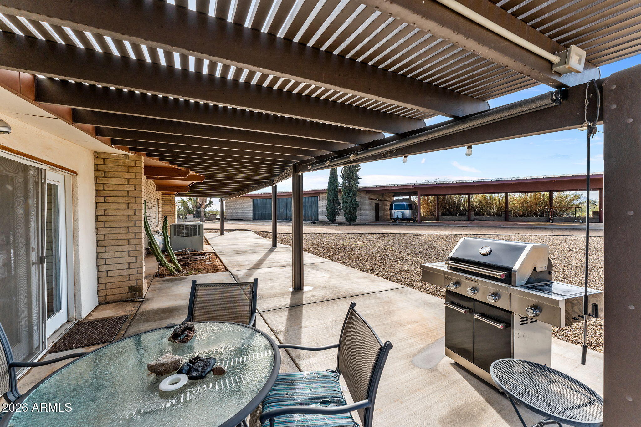 50907 West Iver Road Aguila, AZ 85320 - Photo 28 of 46 a view of a patio with table and chairs with wooden floor