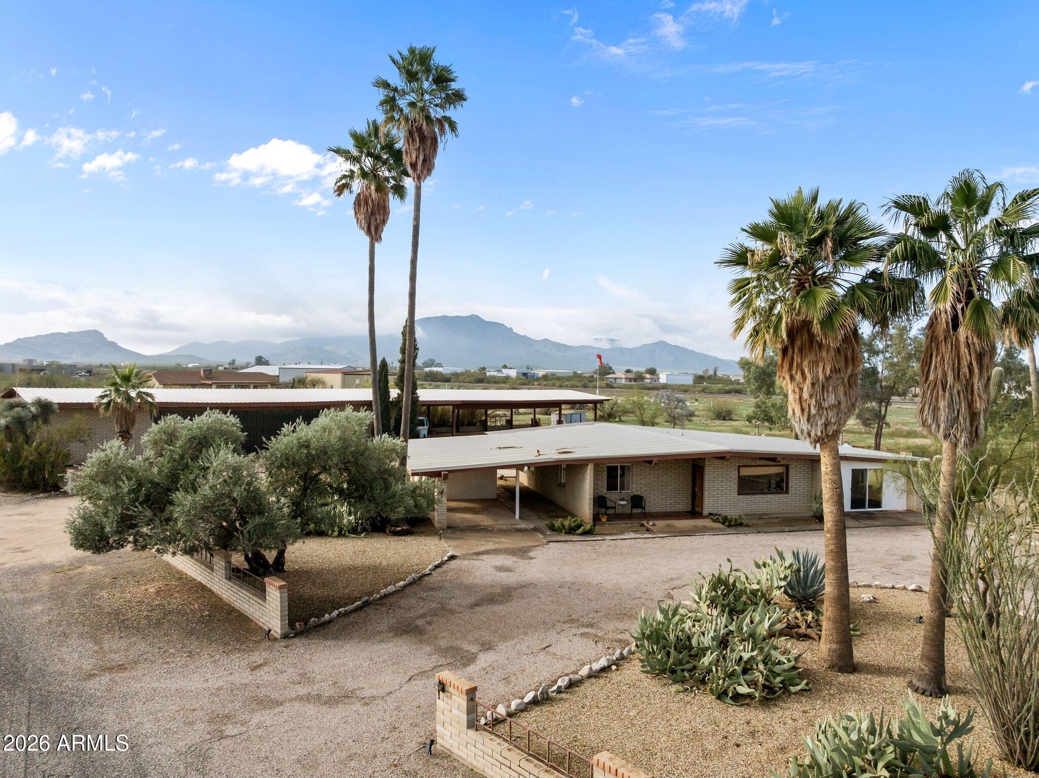 50907 West Iver Road Aguila, AZ 85320 - Photo 45 of 46 a view of a garden with a bench in front of house