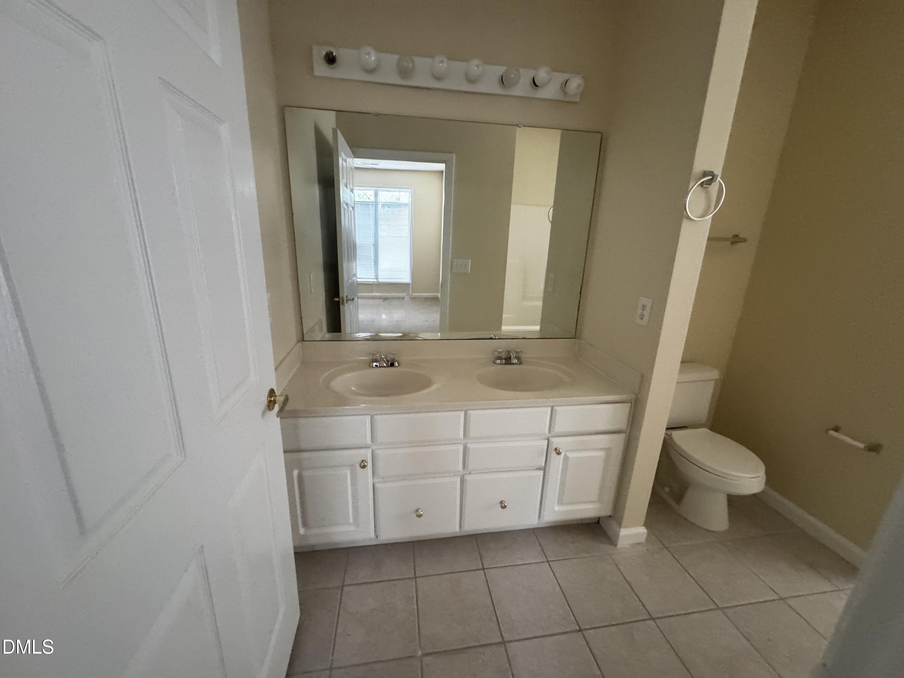 2510 Friedland Place, Unit 202 Raleigh, NC 27617 - Photo 24 of 25 a bathroom with a sink a toilet and mirror