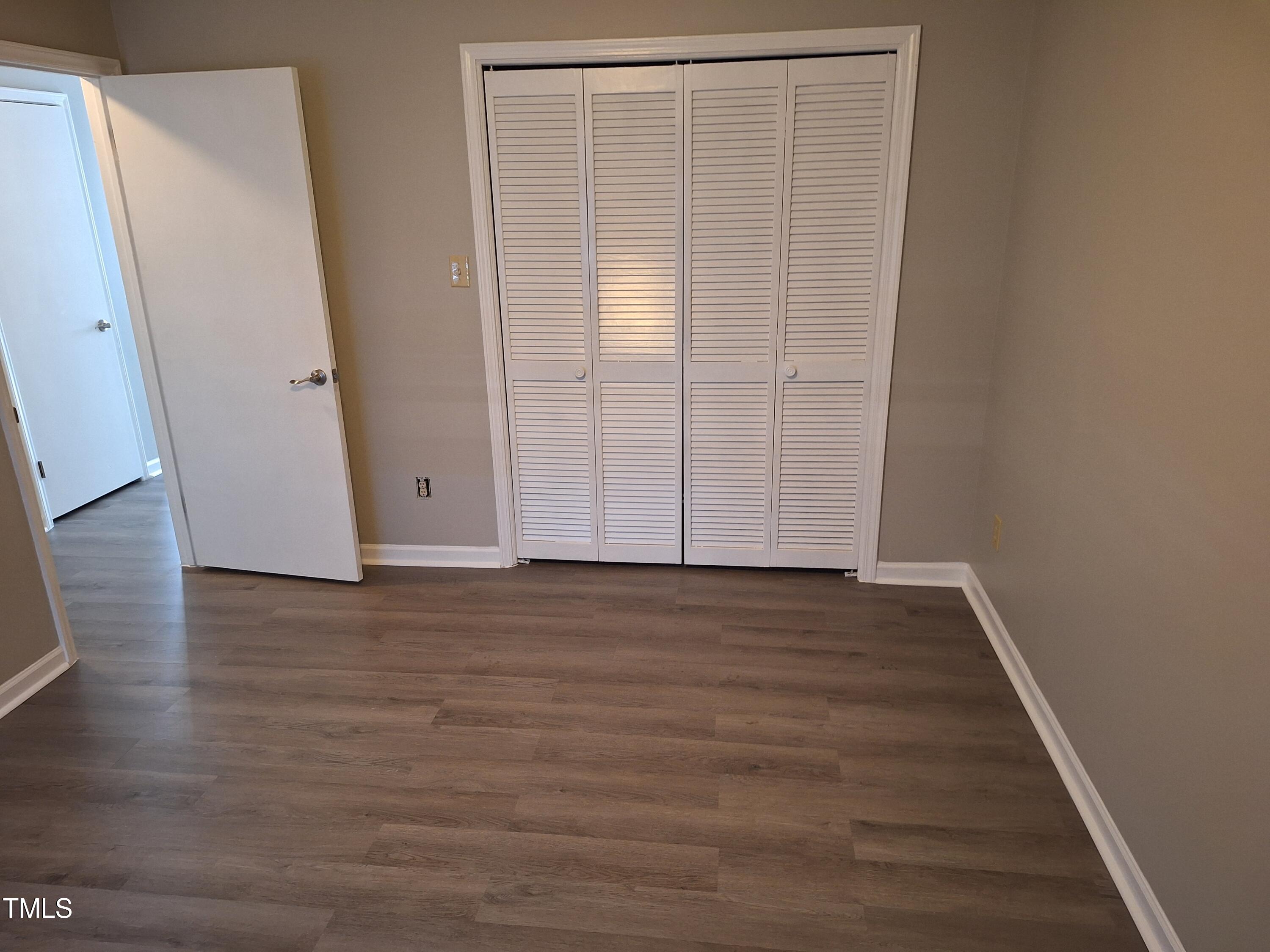 322 Junction Road, Unit 29B Durham, NC 27703 - Photo 11 of 12 an empty room with wooden floor and entrance