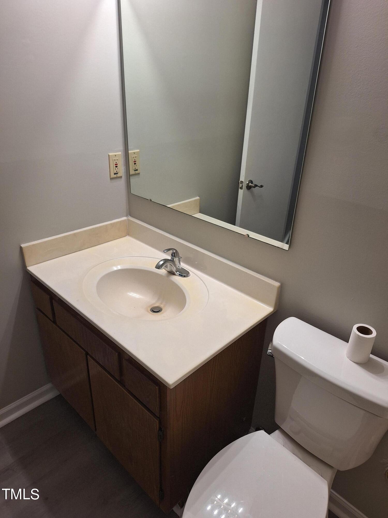 322 Junction Road, Unit 29B Durham, NC 27703 - Photo 6 of 12 a bathroom with a sink vanity mirror and toilet