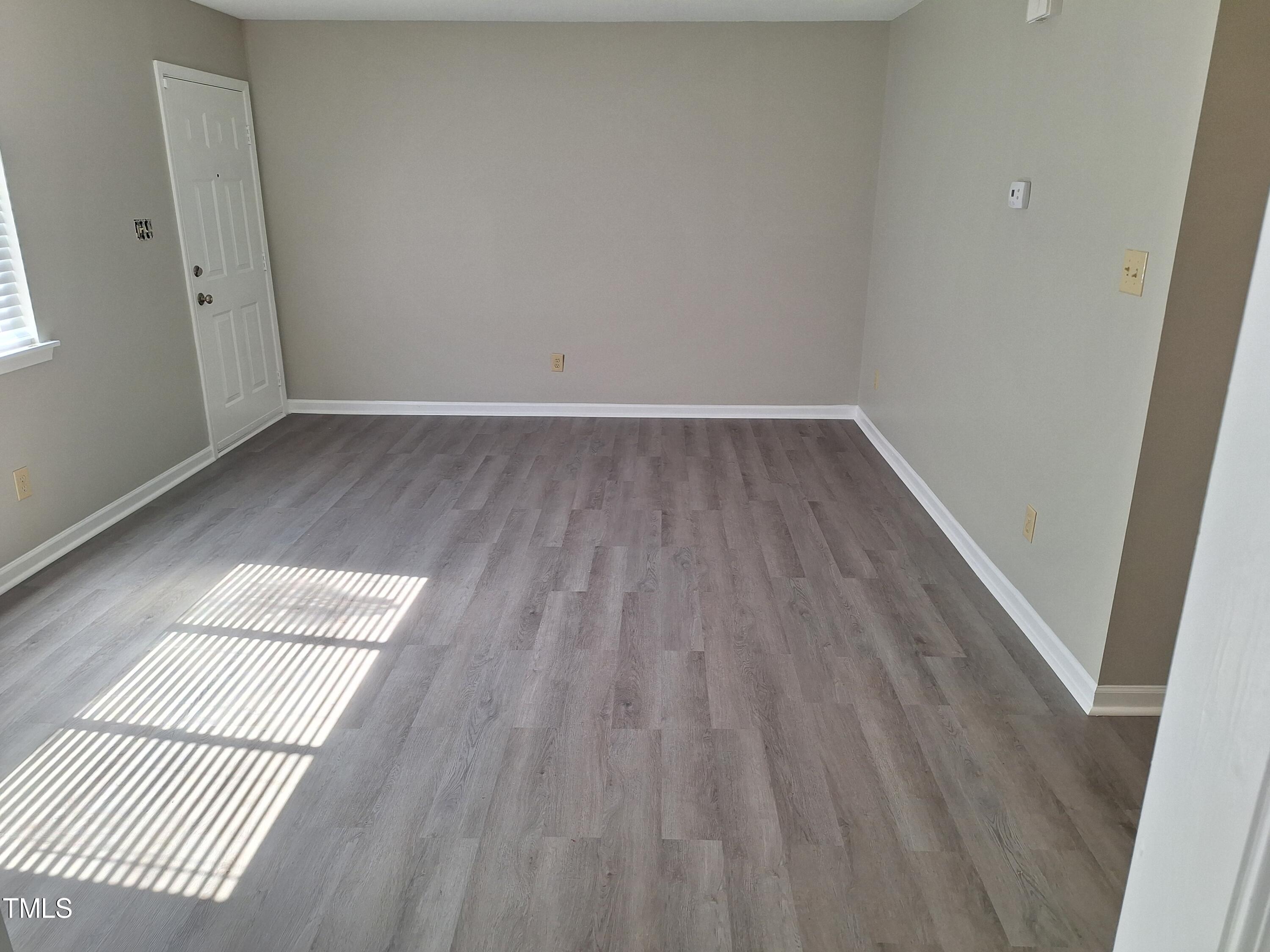 322 Junction Road, Unit 29B Durham, NC 27703 - Photo 7 of 12 an empty room with wooden floor