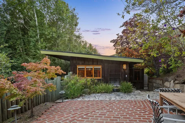 a front view of house with yard and trees around