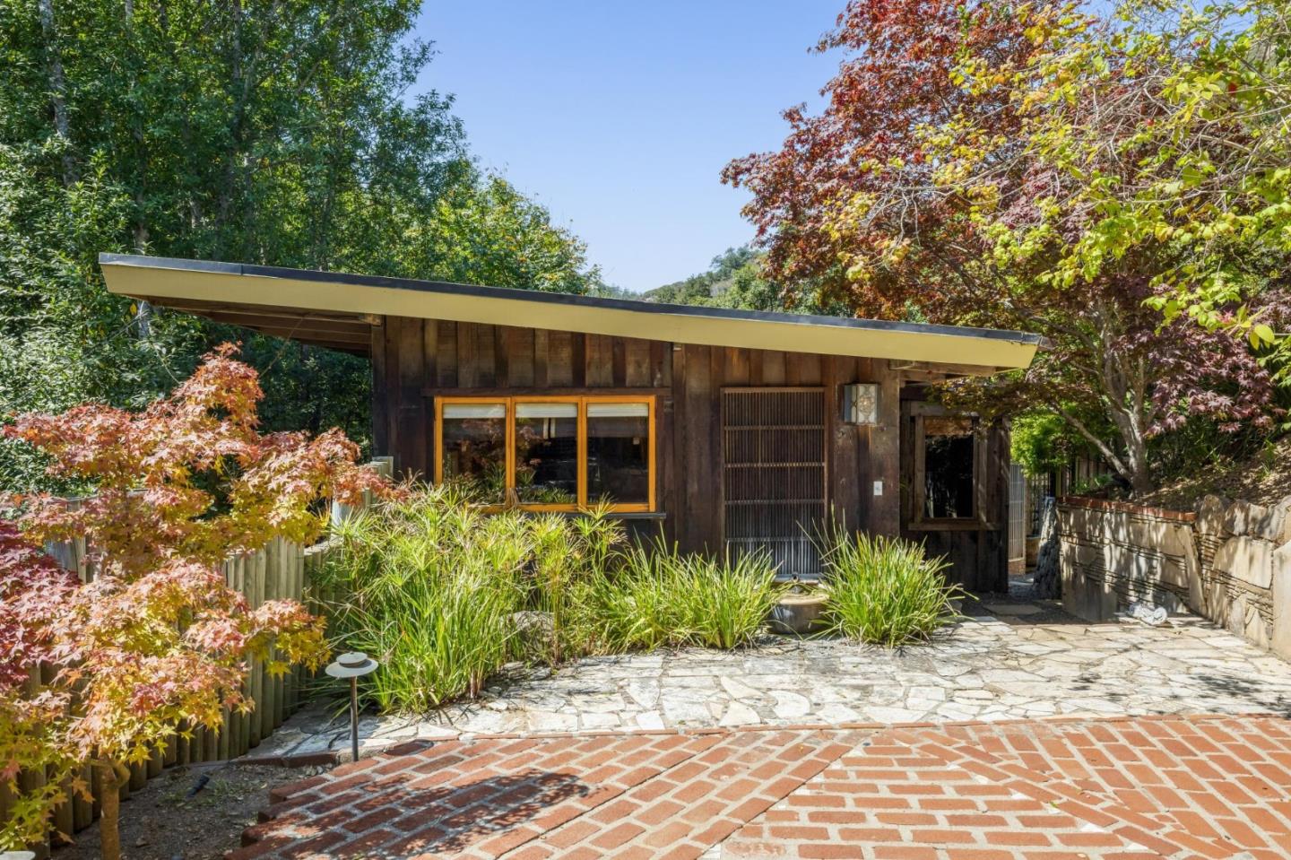 10026 Sycamore Canyon Road Big Sur, CA 93920 - Photo 15 of 67 a front view of a house with garden