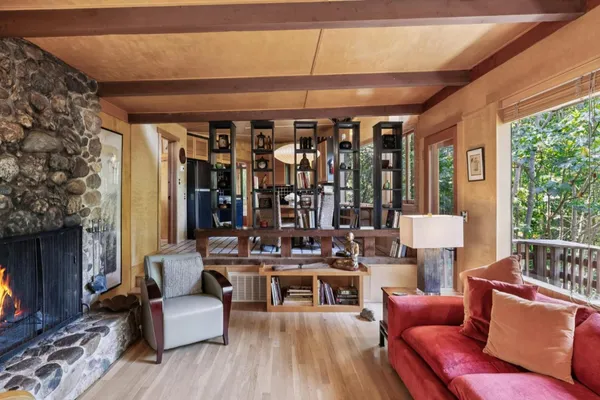 a table and chair sitting in front of a window
