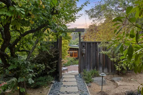 a view of a house with a tree in the background