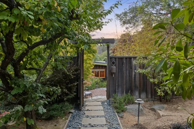 a view of a house with a tree in the background