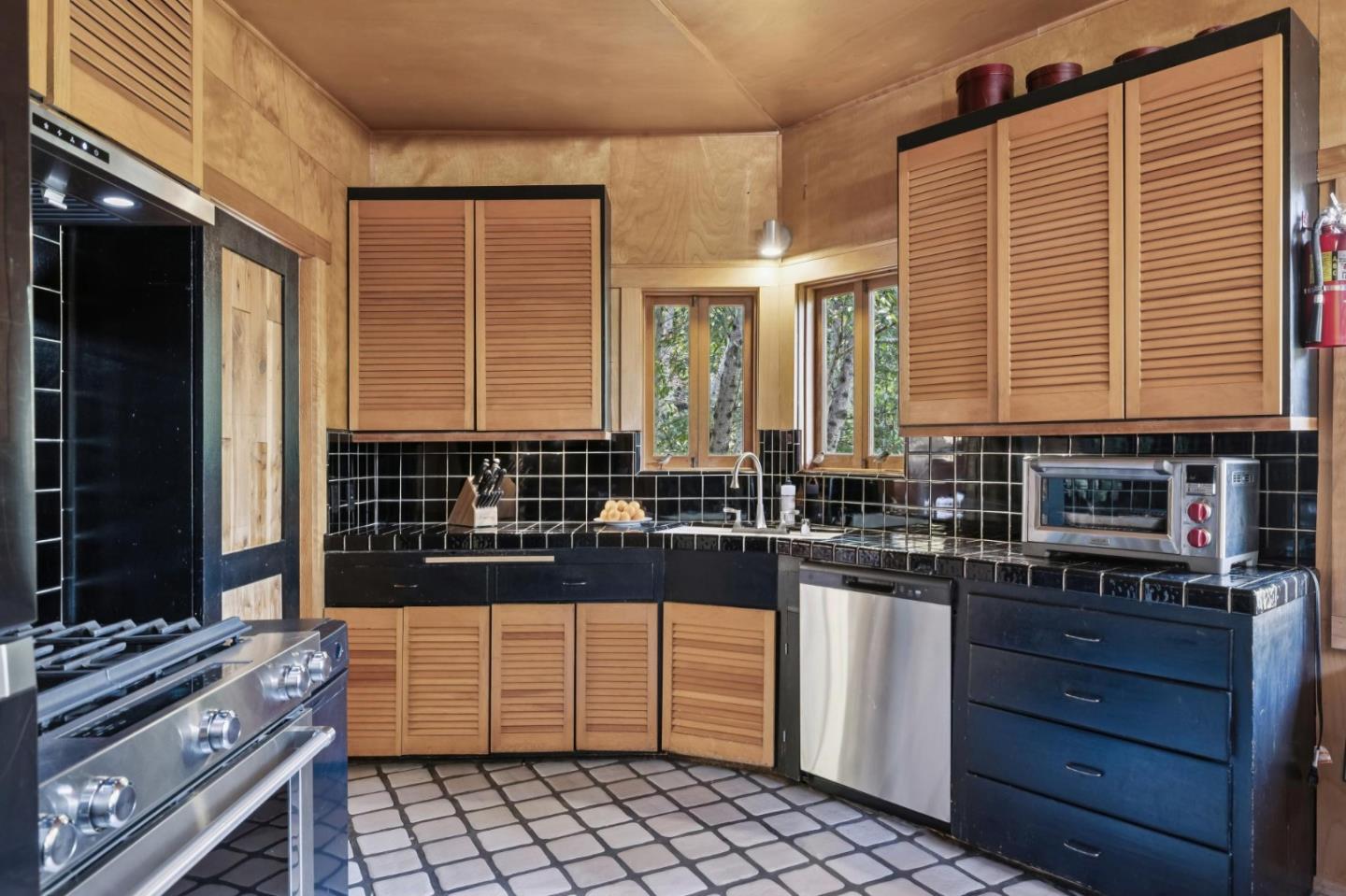 10026 Sycamore Canyon Road Big Sur, CA 93920 - Photo 23 of 67 a kitchen with a sink and cabinets