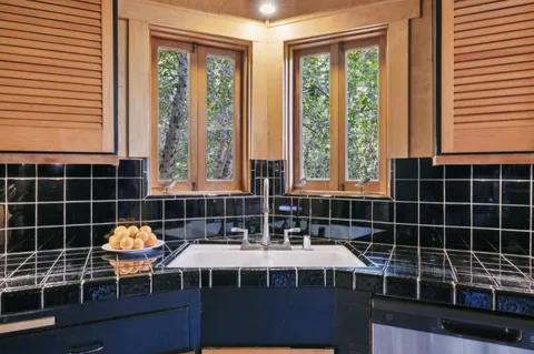 a bathroom with sink a bathtub and next to a window