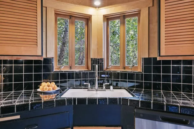 a bathroom with sink a bathtub and next to a window