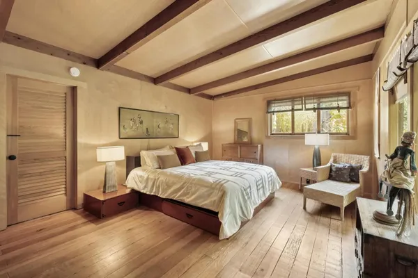 a bedroom with a bed and a mirror
