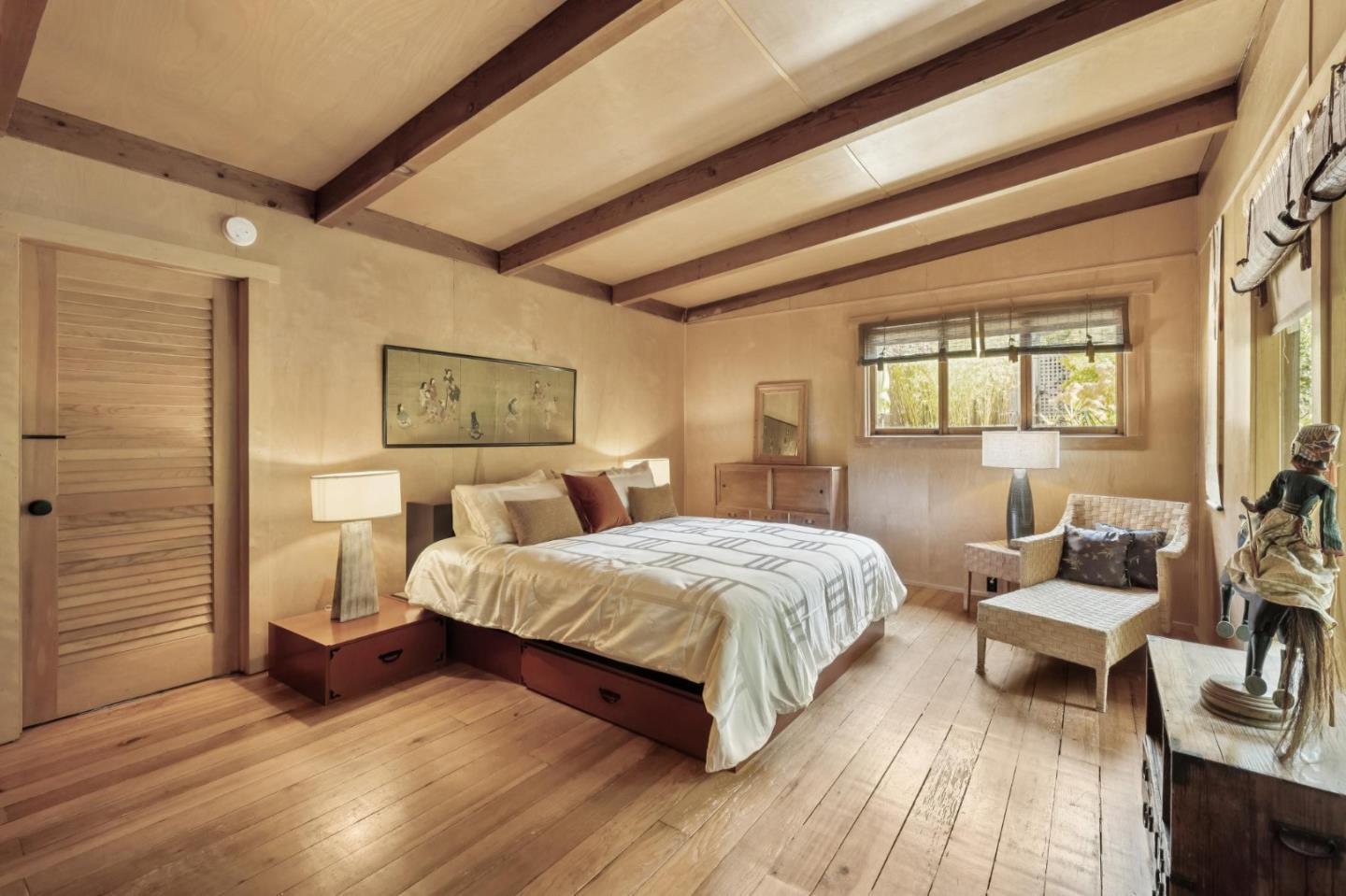 10026 Sycamore Canyon Road Big Sur, CA 93920 - Photo 26 of 67 a bedroom with a bed and wooden floor