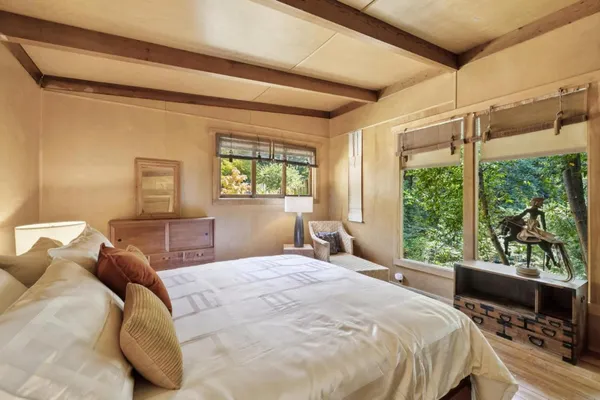 a bedroom with a bed and a television