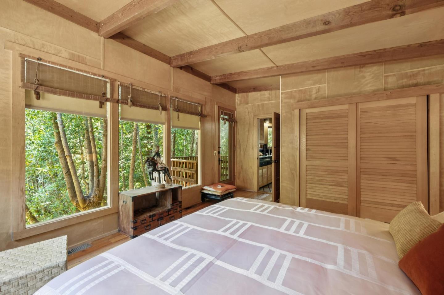 10026 Sycamore Canyon Road Big Sur, CA 93920 - Photo 28 of 67 a bedroom with a bed and a large window