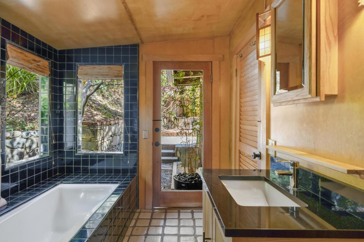 10026 Sycamore Canyon Road Big Sur, CA 93920 - Photo 30 of 67 a bathroom with sink a bathtub and next to a window