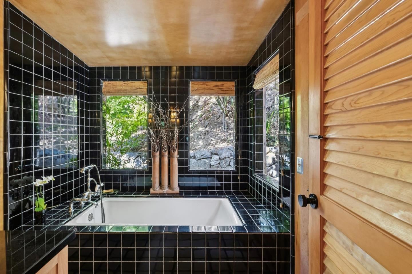 10026 Sycamore Canyon Road Big Sur, CA 93920 - Photo 31 of 67 a bathroom with a bathtub and shower