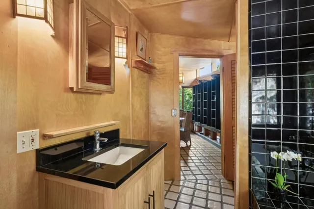 a backyard of a house with large trees and plants