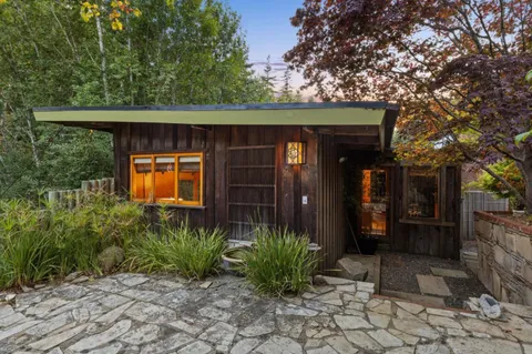 a living room with furniture a ceiling fan and a window