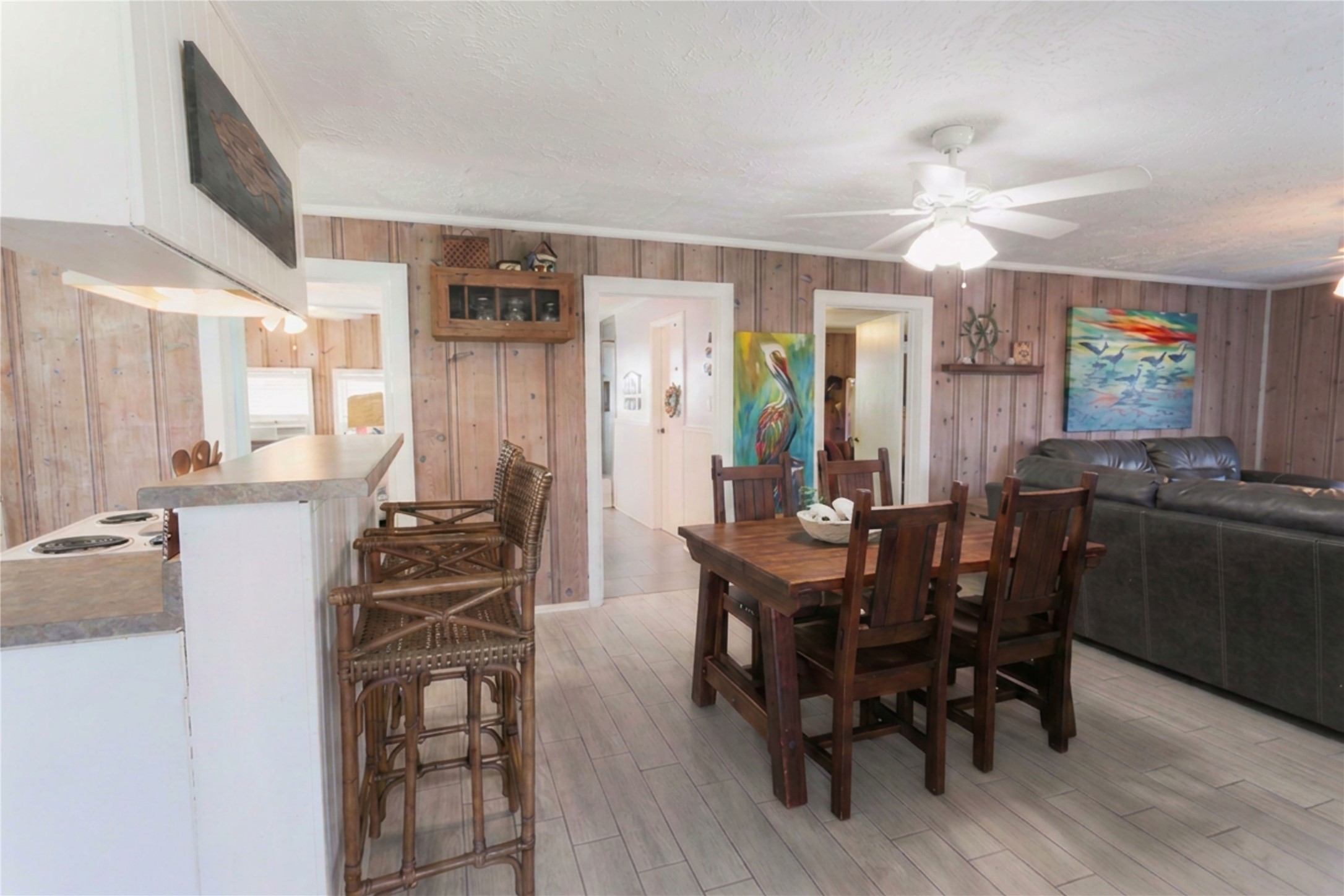 959 South East Road Crystal Beach, TX 77650 - Photo 12 of 20 a view of a dining room with furniture and chandelier