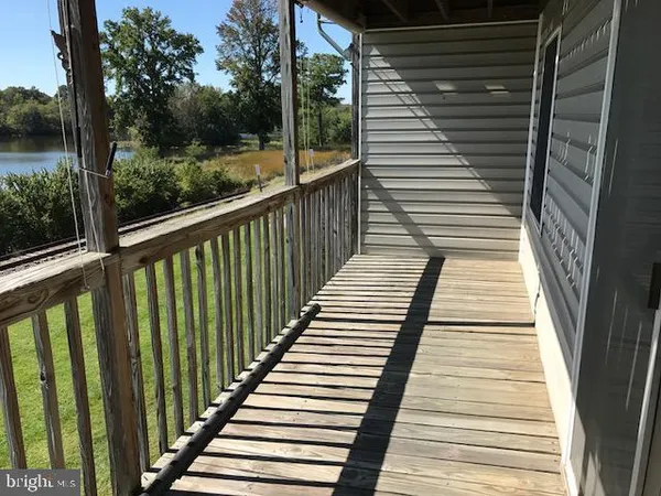 a view of balcony with wooden floor and fence