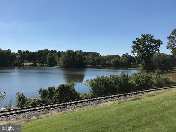 a view of a lake with houses in the back