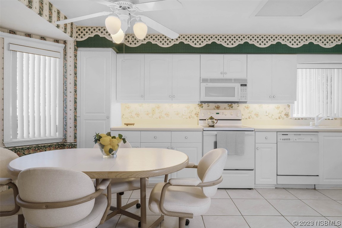 46 Big Buck Trail Ormond Beach, FL 32174 - Photo 11 of 41 a kitchen with a table chairs and white cabinets