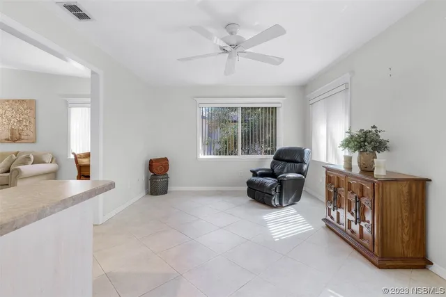 a bedroom with a bed and ceiling fan
