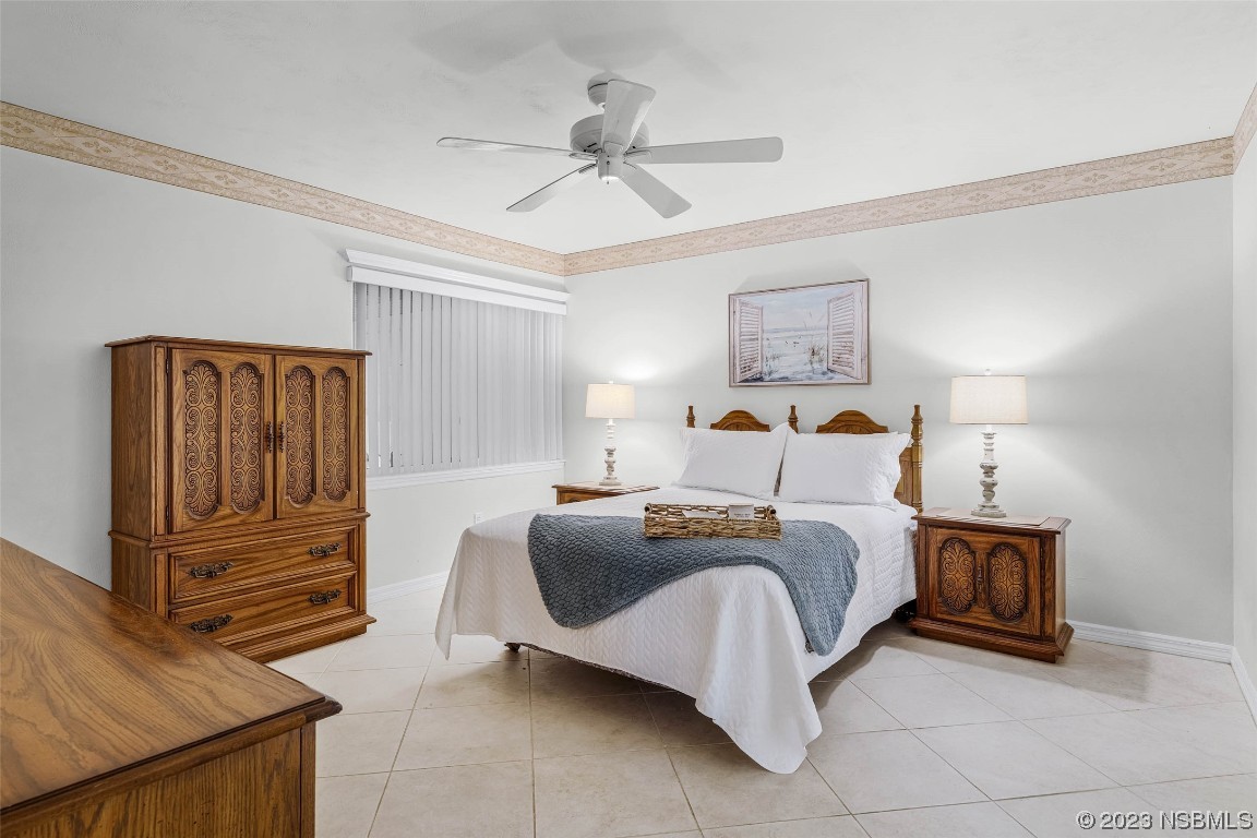 46 Big Buck Trail Ormond Beach, FL 32174 - Photo 22 of 41 a bedroom with a bed and ceiling fan