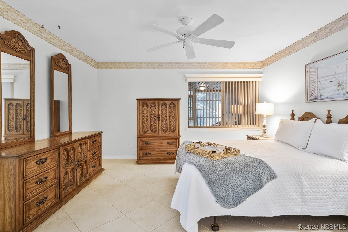 46 Big Buck Trail Ormond Beach, FL 32174 - Photo 23 of 41 a bedroom with a bed a dresser and next to a window