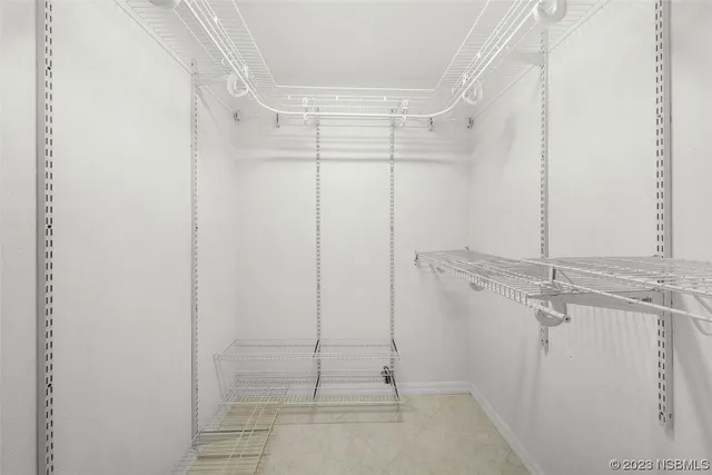 a spacious bathroom with a double vanity sink a mirror and a toilet