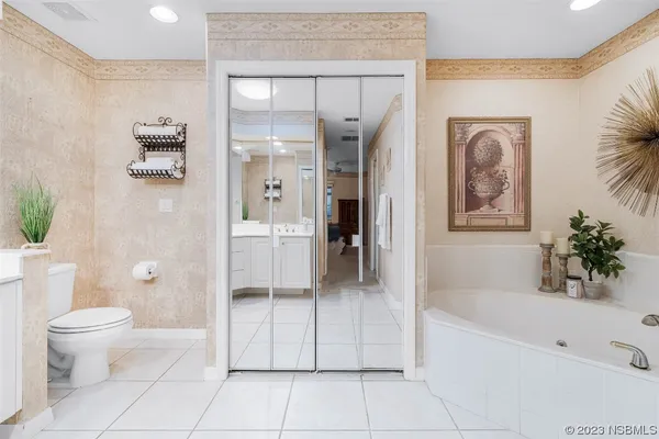 a bathroom with a tub shower and hallway