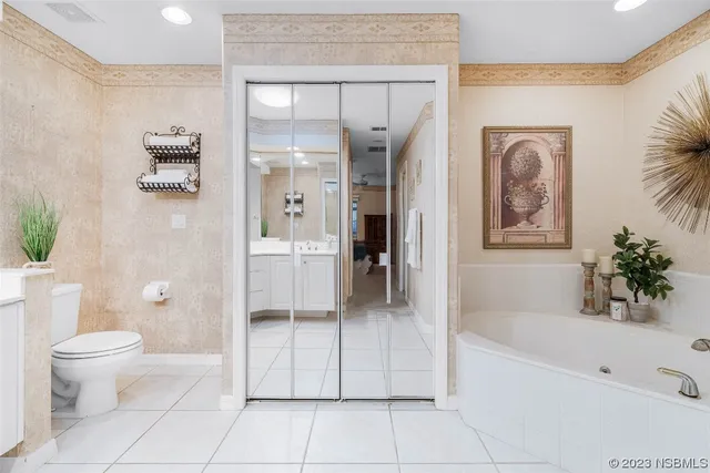 a bathroom with a tub shower and hallway