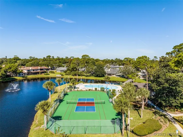a view of a swimming pool with a table and chairs