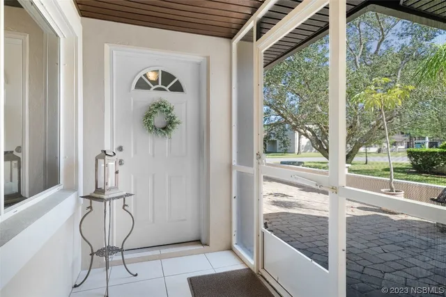 a view of a hallway with wooden floor and dining room view