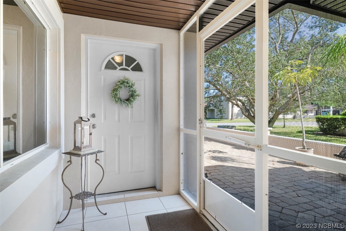 46 Big Buck Trail Ormond Beach, FL 32174 - Photo 6 of 41 a view of a hallway with wooden floor and dining room view