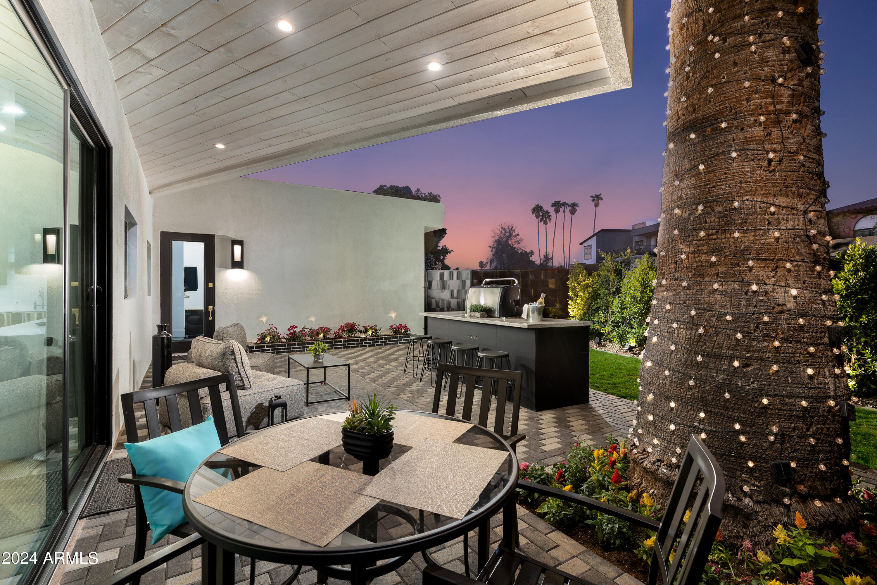 3045 North Marigold Drive Phoenix, AZ 85018 - Photo 47 of 65 a view of a dining room with furniture and a potted plant