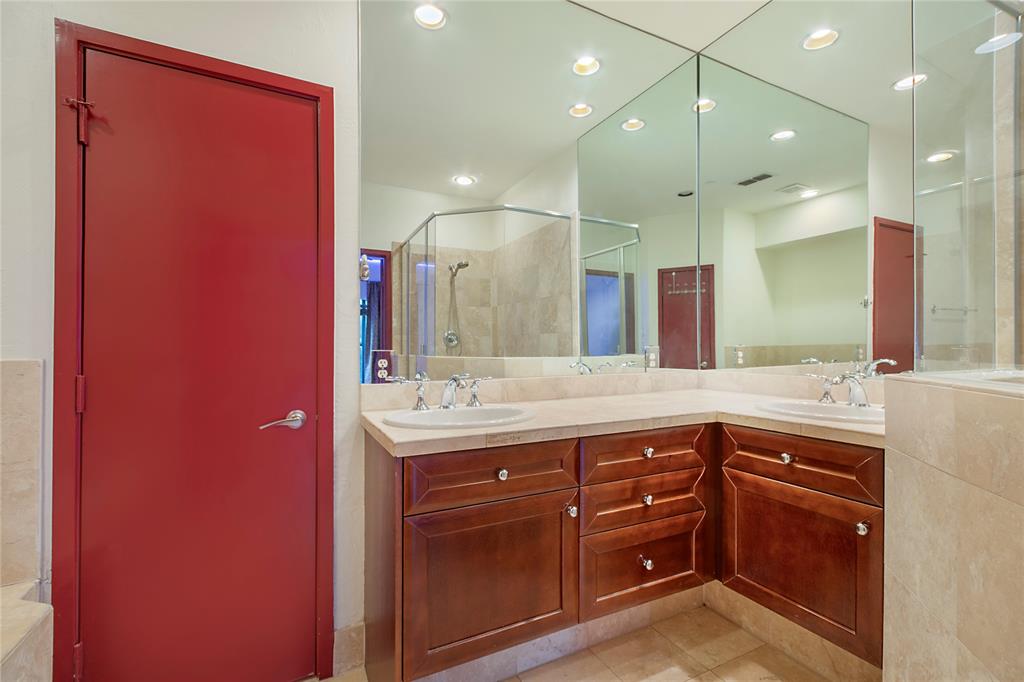 1016 Liberty Street, Unit 4 Dallas, TX 75204 - Photo 24 of 33 a spacious bathroom with a granite countertop sink a mirror and a shower